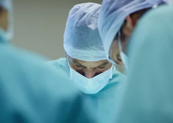 Microsurgeons performing surgery - microsurgery